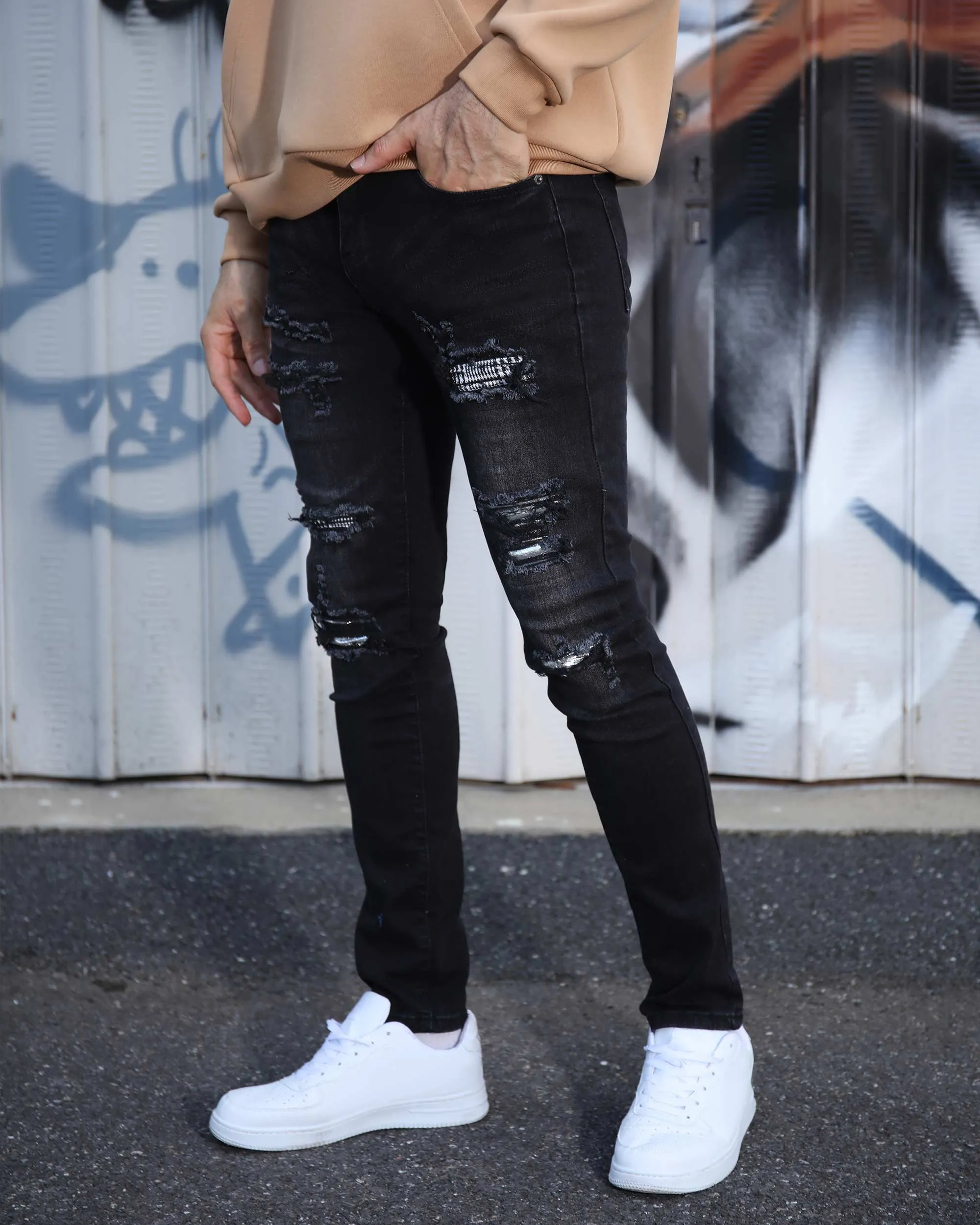 Black Ripped Jeans with Bold Rips and Plaid Patch