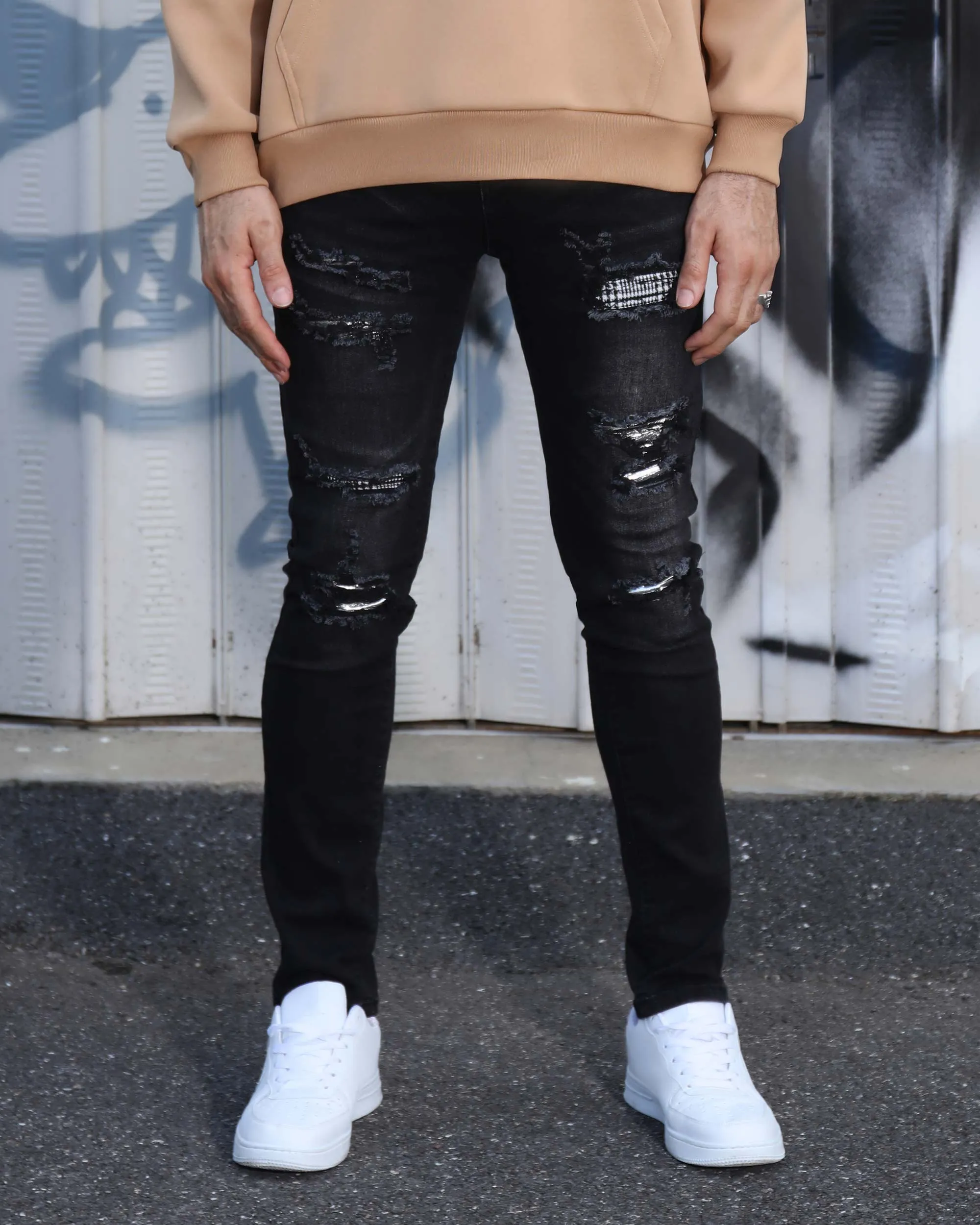 Black Ripped Jeans with Bold Rips and Plaid Patch