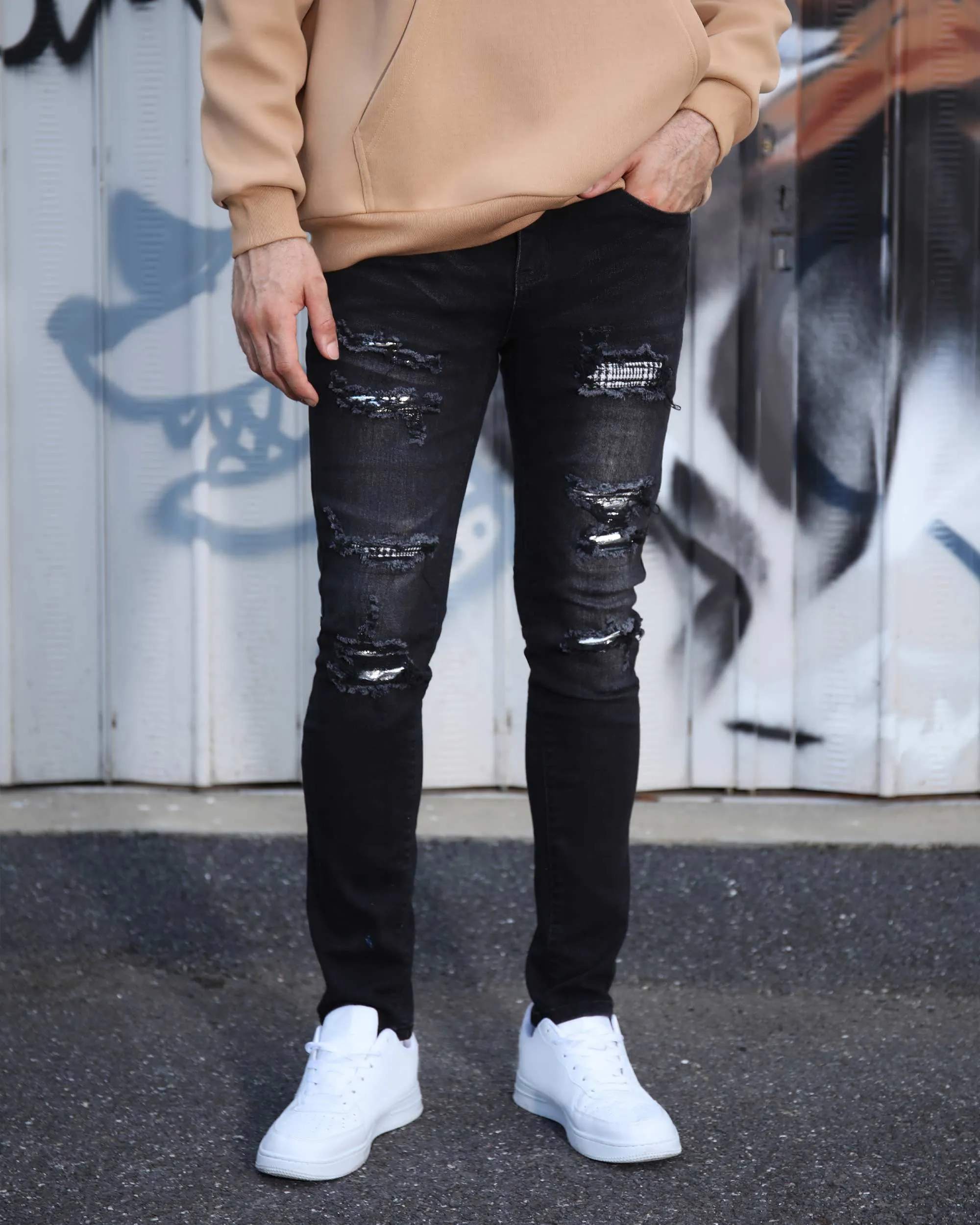 Black Ripped Jeans with Bold Rips and Plaid Patch