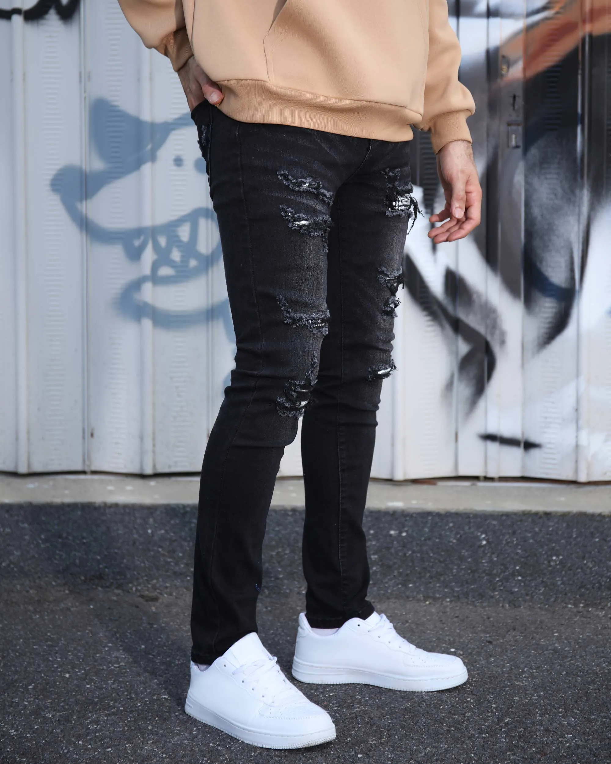 Black Ripped Jeans with Bold Rips and Plaid Patch