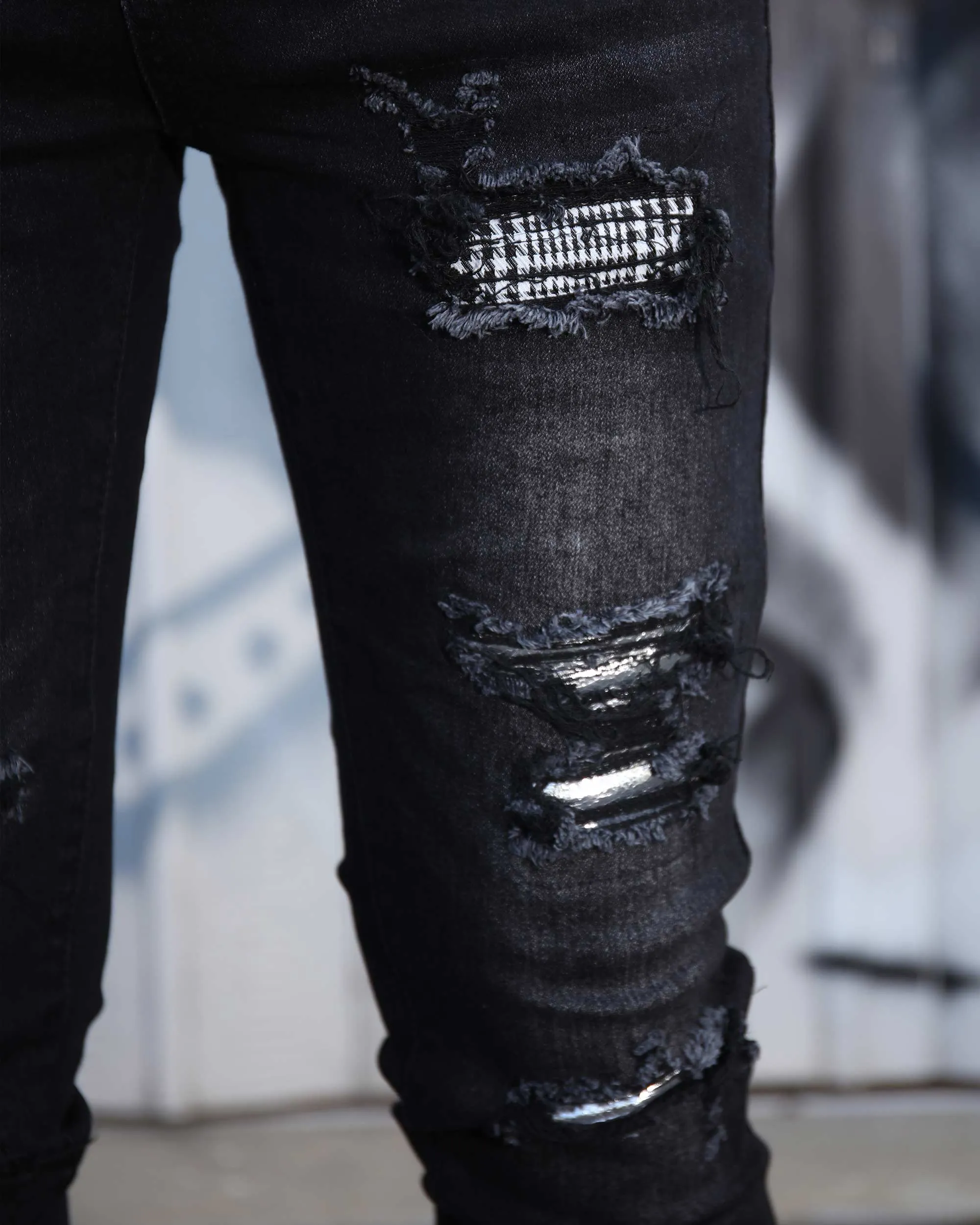 Black Ripped Jeans with Bold Rips and Plaid Patch